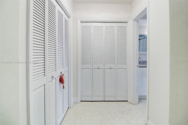 12000 NW 20th St, Pembroke Pines, FL 33026 - hallway featuring speckle patterned floor and baseboards