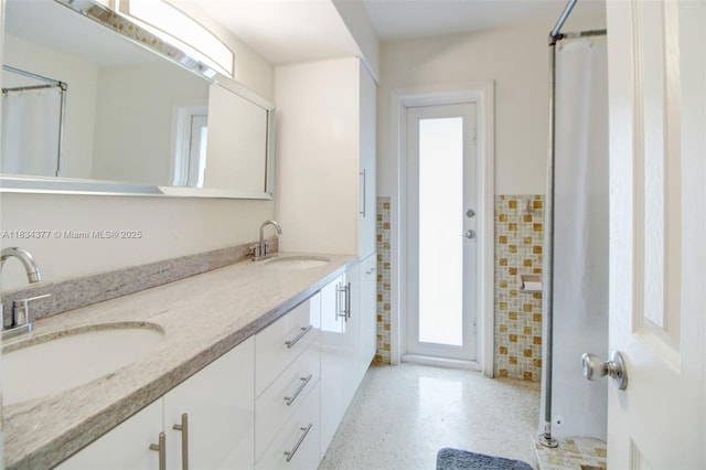 12000 NW 20th St, Pembroke Pines, FL 33026 - bathroom featuring double vanity and speckle patterned floor