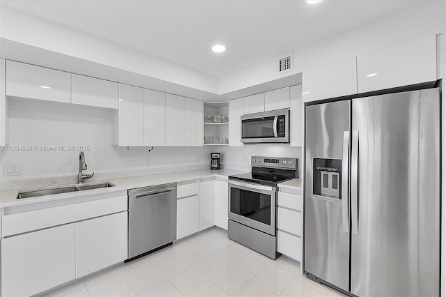 3400 Galt Ocean Dr Unit 702S, Fort Lauderdale, FL 33308 - kitchen with stainless steel appliances, open shelves, light countertops, white cabinets, and recessed lighting