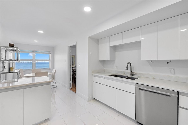 3400 Galt Ocean Dr Unit 702S, Fort Lauderdale, FL 33308 - kitchen with stainless steel dishwasher, light countertops, white cabinets, recessed lighting, and light tile patterned floors