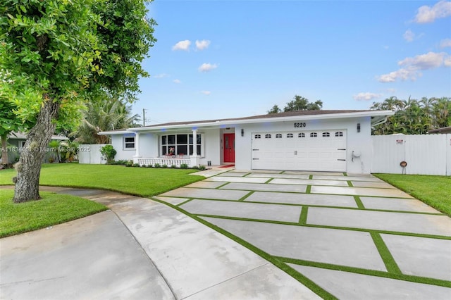 5220 SW 6th St, Plantation, FL 33317 - single story home with concrete driveway, stucco siding, and a garage
