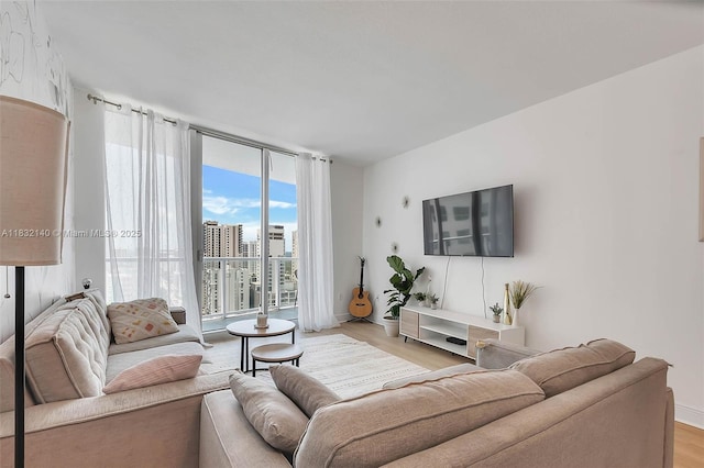 185 SW 7th St Unit 2204, Miami, FL 33130 - living room featuring light wood finished floors and a wall of windows