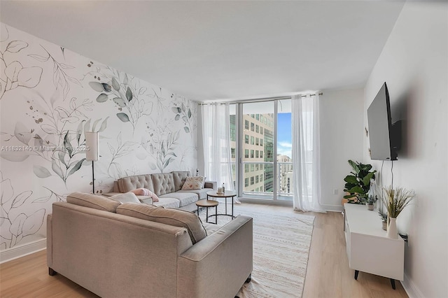 185 SW 7th St Unit 2204, Miami, FL 33130 - living area featuring wallpapered walls, light wood-type flooring, expansive windows, and an accent wall