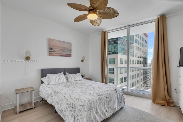 185 SW 7th St Unit 2204, Miami, FL 33130 - bedroom with access to exterior, light wood-style floors, a wall of windows, and a ceiling fan
