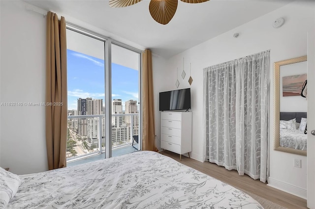 185 SW 7th St Unit 2204, Miami, FL 33130 - bedroom featuring access to exterior, wood finished floors, and ceiling fan