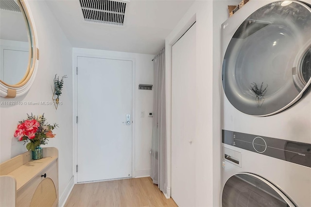 185 SW 7th St Unit 2204, Miami, FL 33130 - washroom featuring stacked washer / dryer and light wood-type flooring