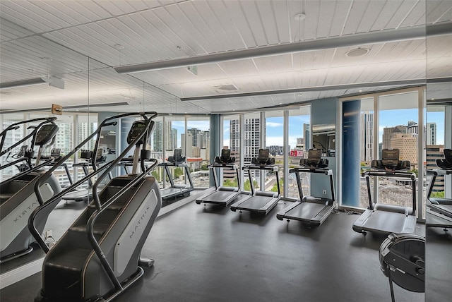 185 SW 7th St Unit 2204, Miami, FL 33130 - gym featuring expansive windows, a skyline view, and healthy amount of natural light