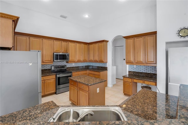 18633 SW 24th St, Miramar, FL 33029 - kitchen with appliances with stainless steel finishes, light tile patterned floors, backsplash, and arched walkways