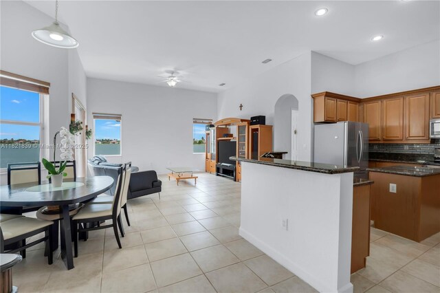 18633 SW 24th St, Miramar, FL 33029 - kitchen featuring appliances with stainless steel finishes, arched walkways, ceiling fan, light tile patterned floors, and decorative backsplash
