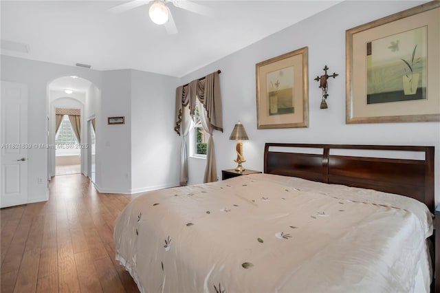 18633 SW 24th St, Miramar, FL 33029 - bedroom featuring arched walkways, multiple windows, hardwood / wood-style floors, and ensuite bath