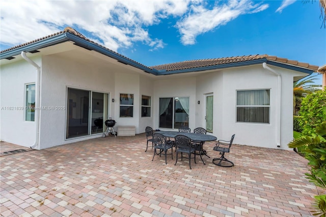 18633 SW 24th St, Miramar, FL 33029 - rear view of property featuring a patio area, stucco siding, a tile roof, and outdoor dining space