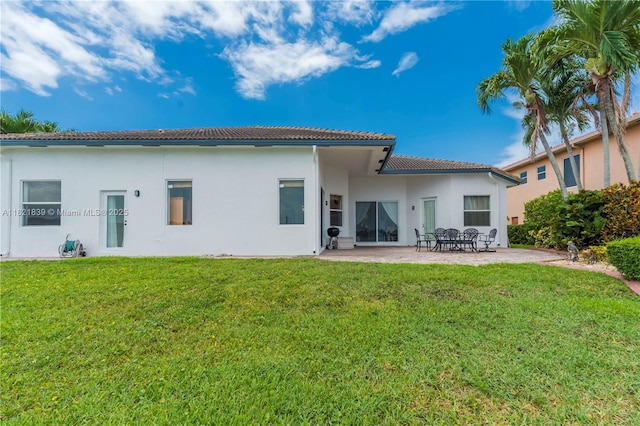 18633 SW 24th St, Miramar, FL 33029 - rear view of property featuring a tiled roof, a patio area, a lawn, and stucco siding