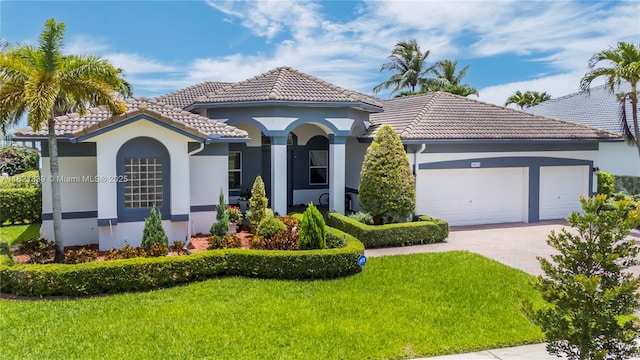 18633 SW 24th St, Miramar, FL 33029 - mediterranean / spanish-style house featuring a tiled roof, stucco siding, a front yard, driveway, and a garage