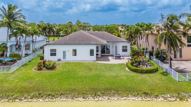 18633 SW 24th St, Miramar, FL 33029 - back of property with stucco siding, a tiled roof, a patio area, and a fenced backyard