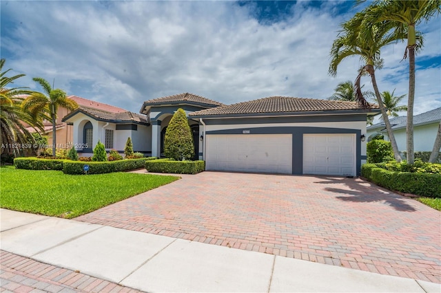 18633 SW 24th St, Miramar, FL 33029 - mediterranean / spanish-style house with decorative driveway, stucco siding, a garage, and a tile roof