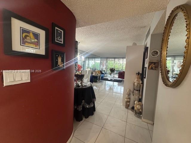 3910 Inverrary Blvd Unit 603-B, Lauderhill, FL 33319 - corridor featuring a textured ceiling and light tile patterned floors