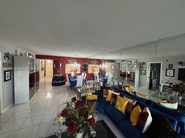 3910 Inverrary Blvd Unit 603-B, Lauderhill, FL 33319 - living area with a textured ceiling and light tile patterned flooring