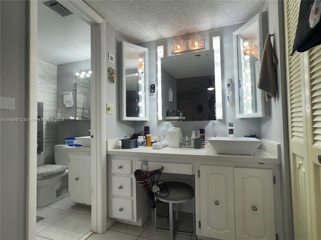 3910 Inverrary Blvd Unit 603-B, Lauderhill, FL 33319 - bathroom featuring tile patterned floors, vanity, a textured ceiling, and a closet