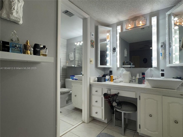 3910 Inverrary Blvd Unit 603-B, Lauderhill, FL 33319 - bathroom featuring tile patterned flooring, vanity, and a textured ceiling
