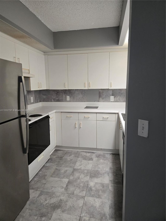 800 SW 142nd Ave Unit N111, Pembroke Pines, FL 33027 - kitchen with freestanding refrigerator, white electric stove, under cabinet range hood, a textured ceiling, and light countertops