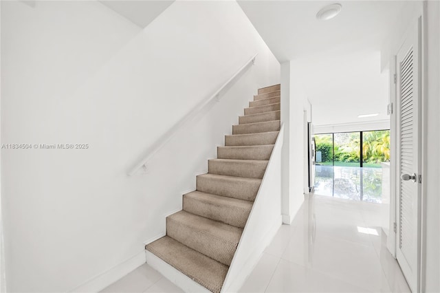 20218 NE 34th Ct Unit 52, Aventura, FL 33180 - stairway with tile patterned flooring and baseboards