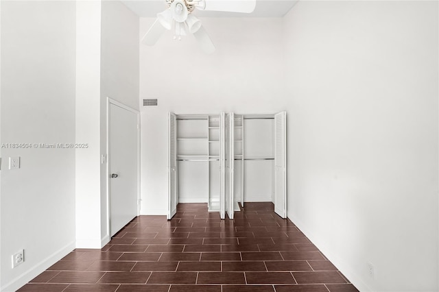 20218 NE 34th Ct Unit 52, Aventura, FL 33180 - unfurnished bedroom featuring wood tiled floors, ceiling fan, and two closets