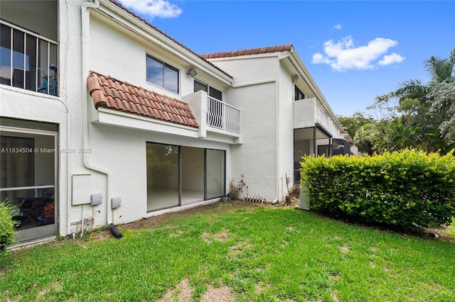 20218 NE 34th Ct Unit 52, Aventura, FL 33180 - rear view of property featuring a tile roof, stucco siding, and a lawn