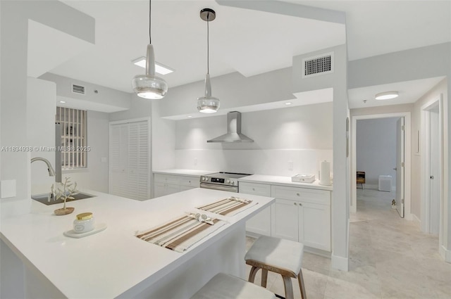 3205 NE 184th St Unit 9106, Aventura, FL 33160 - kitchen with wall chimney range hood, stainless steel range with electric cooktop, white cabinetry, light countertops, and a breakfast bar area