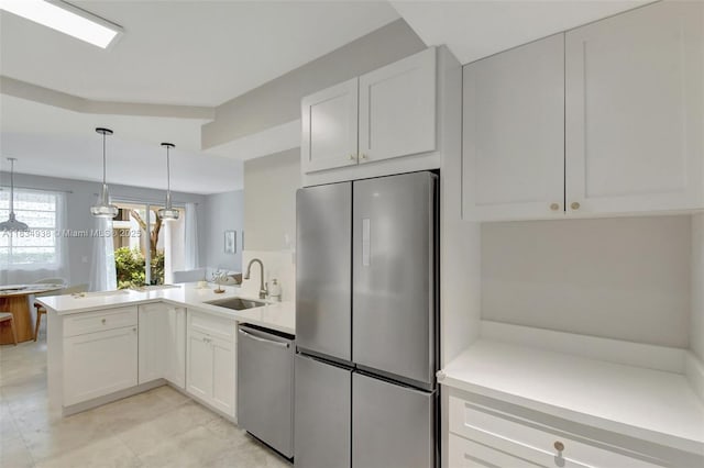 3205 NE 184th St Unit 9106, Aventura, FL 33160 - kitchen with appliances with stainless steel finishes, a peninsula, white cabinetry, and light countertops