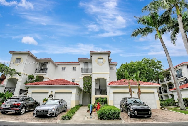 3205 NE 184th St Unit 9106, Aventura, FL 33160 - view of front of property with a garage, stucco siding, driveway, and a tile roof