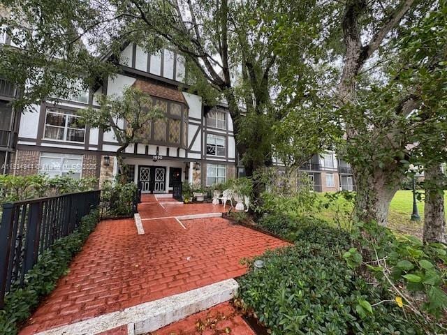 3690 Inverrary Dr Unit 1T, Lauderhill, FL 33319 - rear view of house with french doors and brick siding