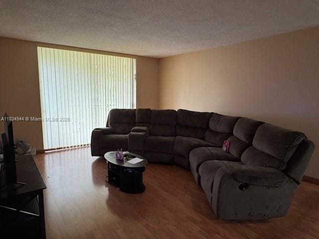 3690 Inverrary Dr Unit 1T, Lauderhill, FL 33319 - living room featuring wood finished floors and a textured ceiling