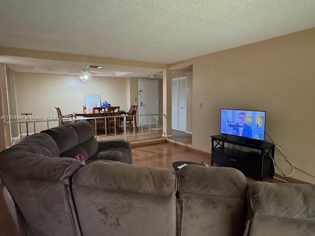 3690 Inverrary Dr Unit 1T, Lauderhill, FL 33319 - living room featuring a textured ceiling