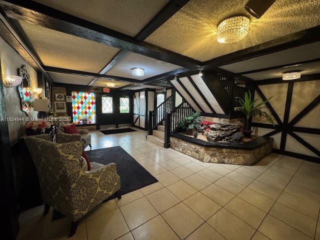 3690 Inverrary Dr Unit 1T, Lauderhill, FL 33319 - common area featuring stairway and beam ceiling