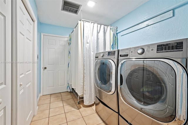 14040 SW 14th St, Davie, FL 33325 - laundry area featuring light tile patterned floors and washer and clothes dryer