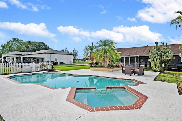 14040 SW 14th St, Davie, FL 33325 - view of pool featuring a patio, a fenced backyard, a sunroom, and a pool with connected hot tub