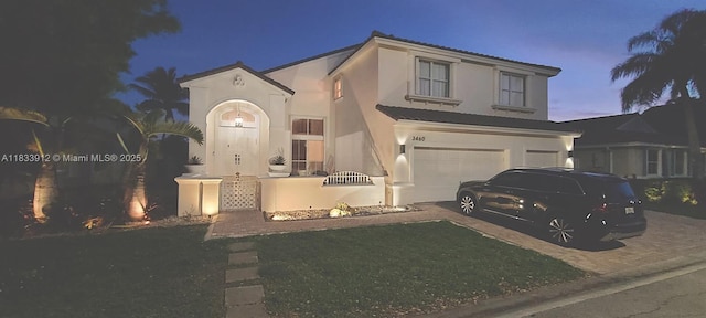 3460 SW 52nd St, Hollywood, FL 33312 - mediterranean / spanish house featuring asphalt driveway, stucco siding, and an attached garage