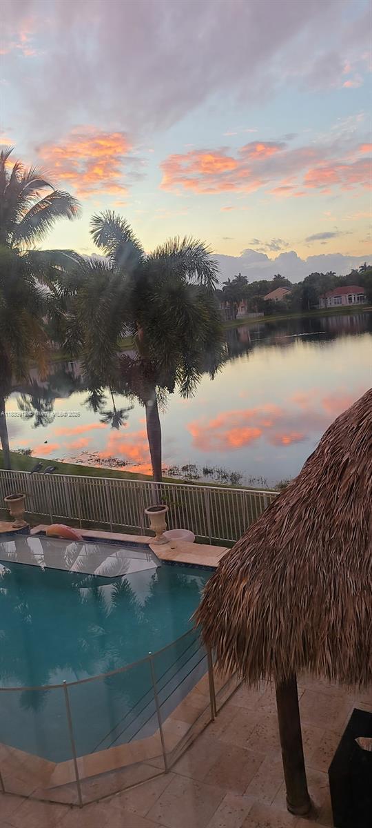 3460 SW 52nd St, Hollywood, FL 33312 - pool at dusk with a water view and an outdoor pool