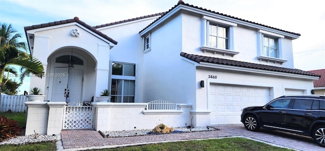 3460 SW 52nd St, Hollywood, FL 33312 - mediterranean / spanish home with a fenced front yard, a garage, stucco siding, a tiled roof, and a gate