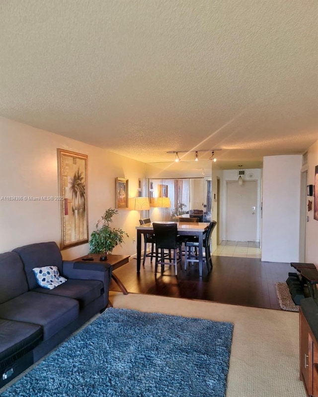 1470 NE 125th Ter Unit 814, North Miami, FL 33161 - living room featuring a textured ceiling and light wood finished floors