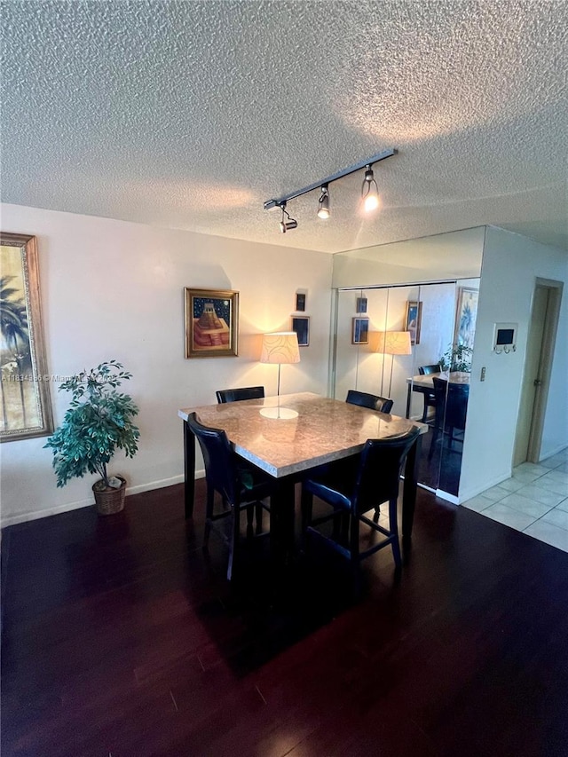 1470 NE 125th Ter Unit 814, North Miami, FL 33161 - dining room with wood finished floors, track lighting, and a textured ceiling