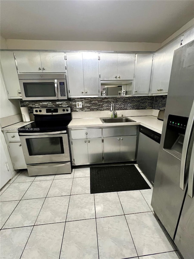 1470 NE 125th Ter Unit 814, North Miami, FL 33161 - kitchen featuring appliances with stainless steel finishes, tasteful backsplash, light countertops, and light tile patterned floors