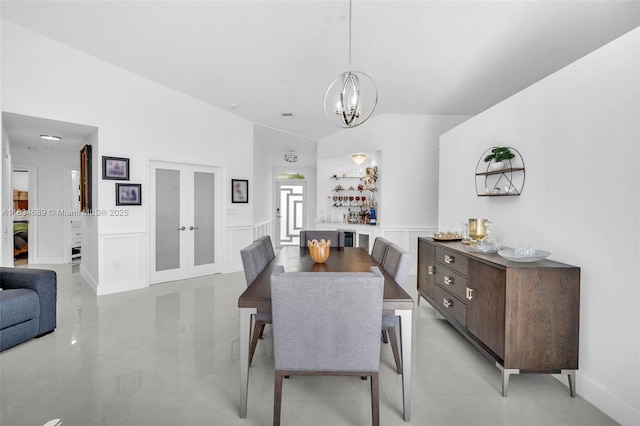 1211 E Wilshire Cir, Pembroke Pines, FL 33027 - dining space with lofted ceiling, a chandelier, french doors, and wainscoting
