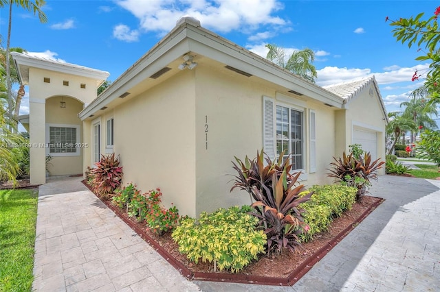 1211 E Wilshire Cir, Pembroke Pines, FL 33027 - view of home's exterior featuring an attached garage and stucco siding