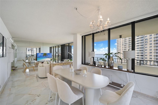 520 Brickell Key Dr Unit A1115, Miami, FL 33131 - dining room featuring a chandelier, marble finish flooring, and a textured ceiling