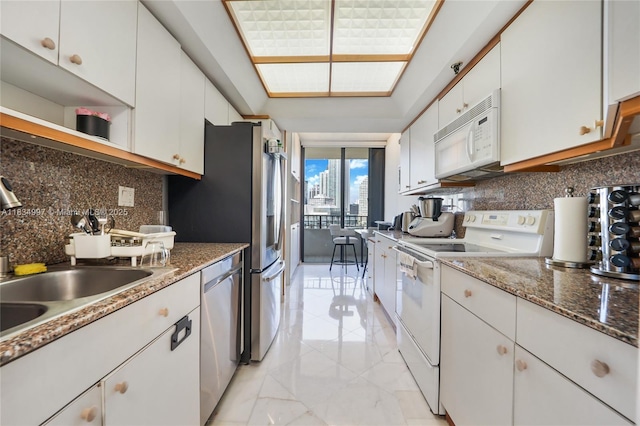 520 Brickell Key Dr Unit A1115, Miami, FL 33131 - kitchen with white appliances, decorative backsplash, white cabinetry, open shelves, and a wall of windows