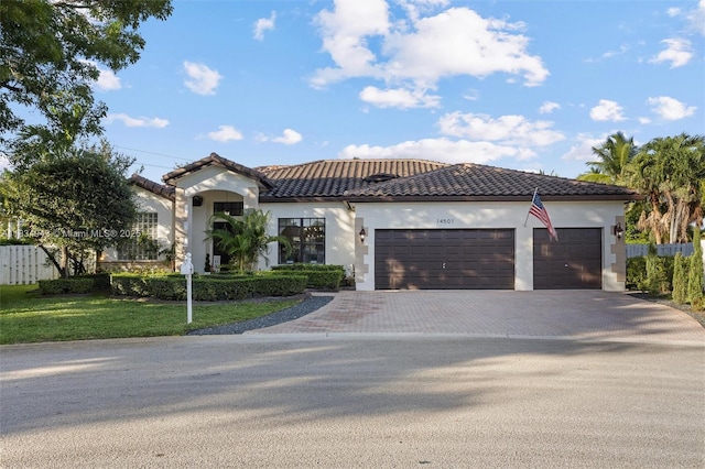 14501 SW 33rd Ct, Miramar, FL 33027 - mediterranean / spanish home with driveway, a garage, stucco siding, and a tiled roof