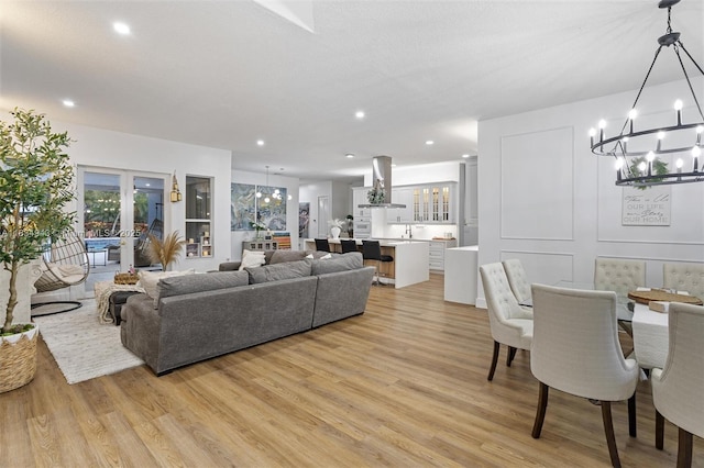 14501 SW 33rd Ct, Miramar, FL 33027 - living room with a chandelier, light wood-type flooring, recessed lighting, and healthy amount of natural light