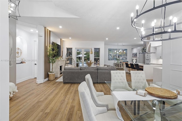 14501 SW 33rd Ct, Miramar, FL 33027 - dining space featuring a chandelier, light wood finished floors, recessed lighting, and a premium fireplace