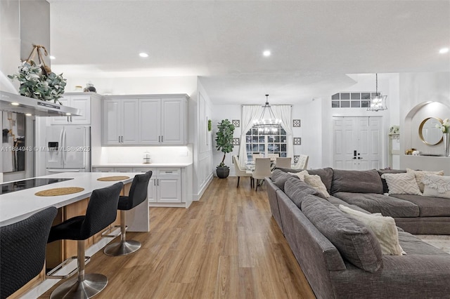 14501 SW 33rd Ct, Miramar, FL 33027 - living room featuring a chandelier, light wood-type flooring, and recessed lighting